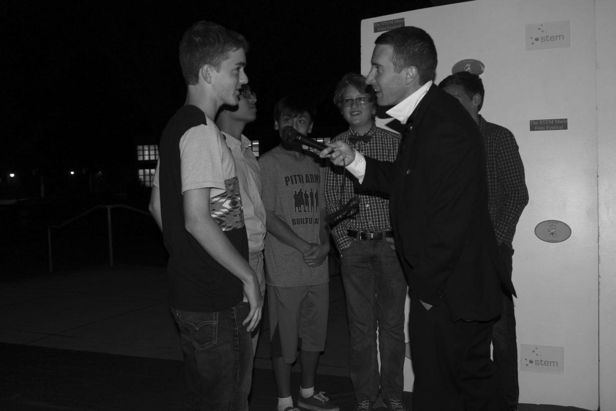 STEM teacher Nick Williams interviewed freshmen Caleb Ryan, Ethan Cadaoas and Wesley Fink on the red carpet. [Elise Jonas-Delson]