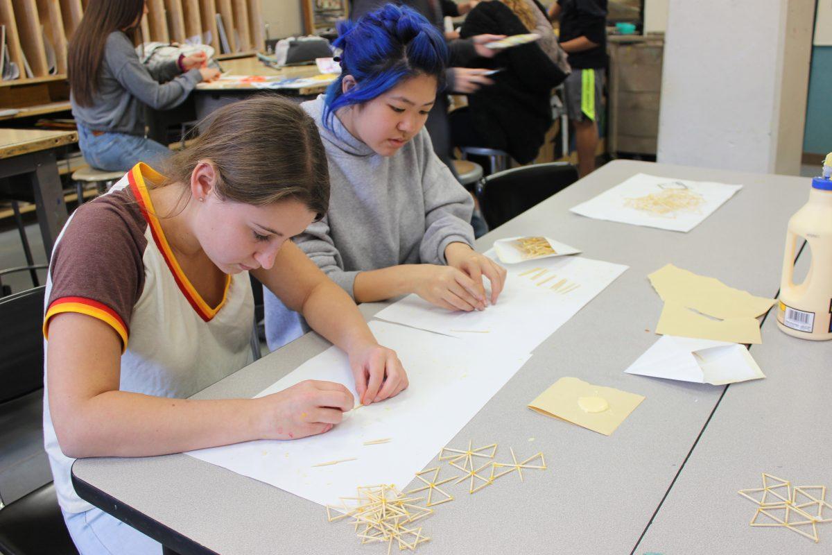 Juniors Trinity Landis (left) and Riley Mar craft toothpick art. [Emma Robertson]