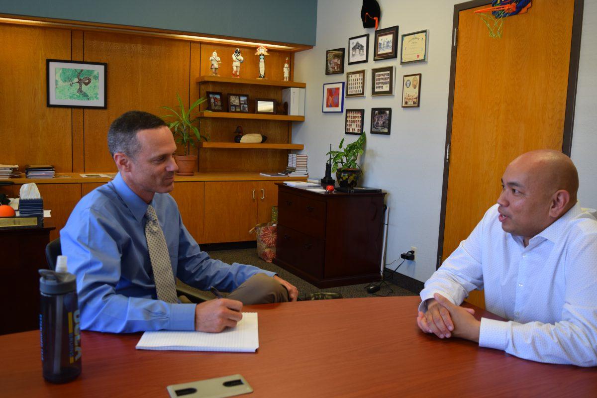 Superintendent Kris Cosca (left) speaks with Assistant Superintendent of Human Resources Jonathan Ferrer. As the school year began, Cosca worked with Ferrer to hire new teachers. 
