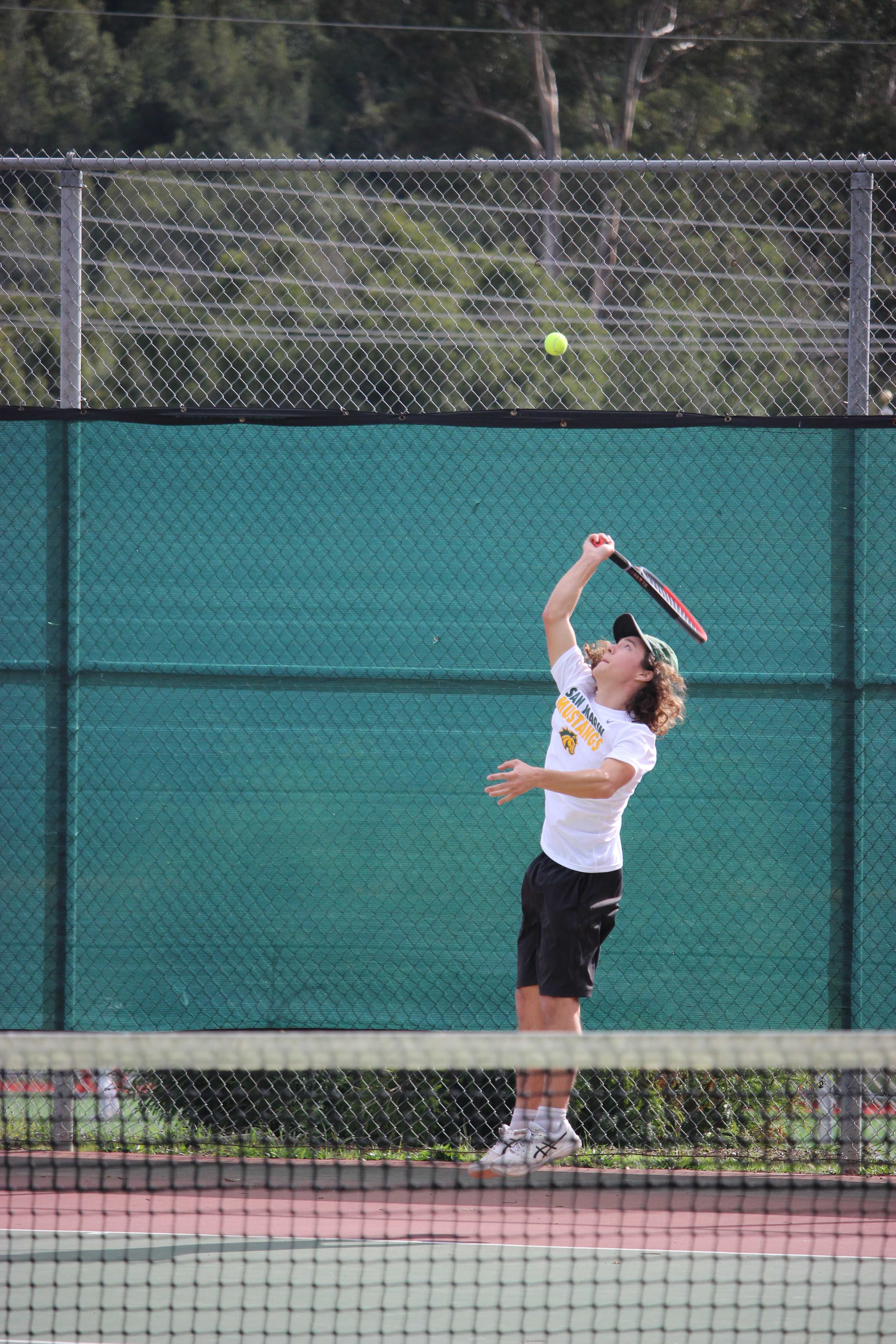 Boys Tennis Senior Jesse Chi serves against San Rafael High School. He beat his opponent 6-1, 6-1.