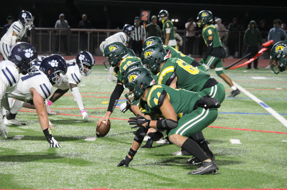 Senior Tyler Keehn lines up the ball, with San Marin's offense alongside him hoping to run it into the end zone.