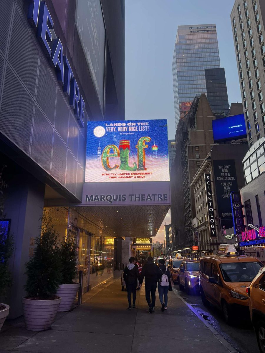 A marquee advertising for "Elf: The Musical" outside of the Marquis Theatre in New York City.