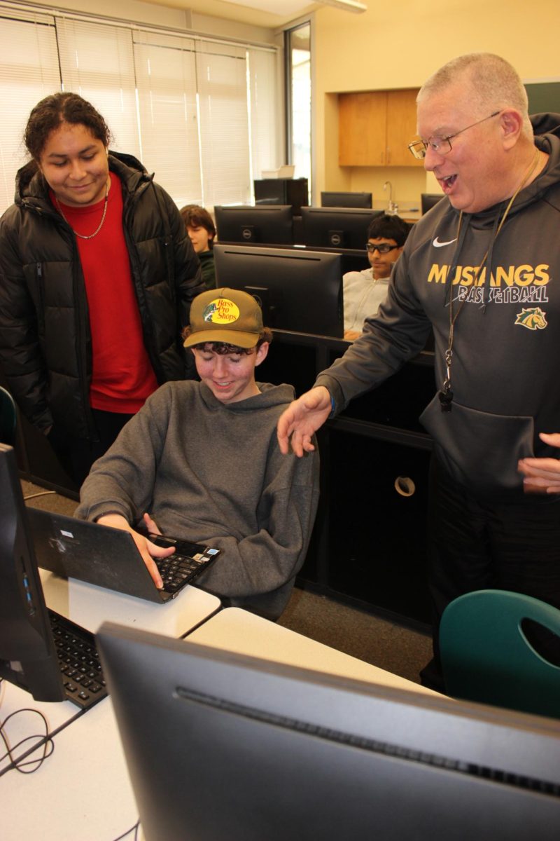 CISCO teacher Gregory Irish teaches his students how to fix a broken laptop