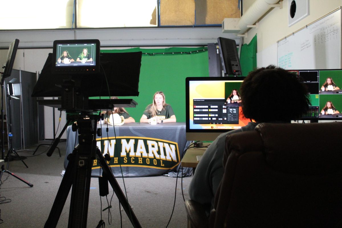 Senior Malakhi Lindsey records Ruth Brewer and Izzy Gray during their public broadcasting to San Marin students un "From the Mustang's Mouth."
