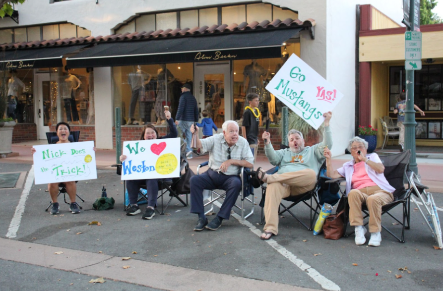 San Marin family members cheer on the parade sidelines 