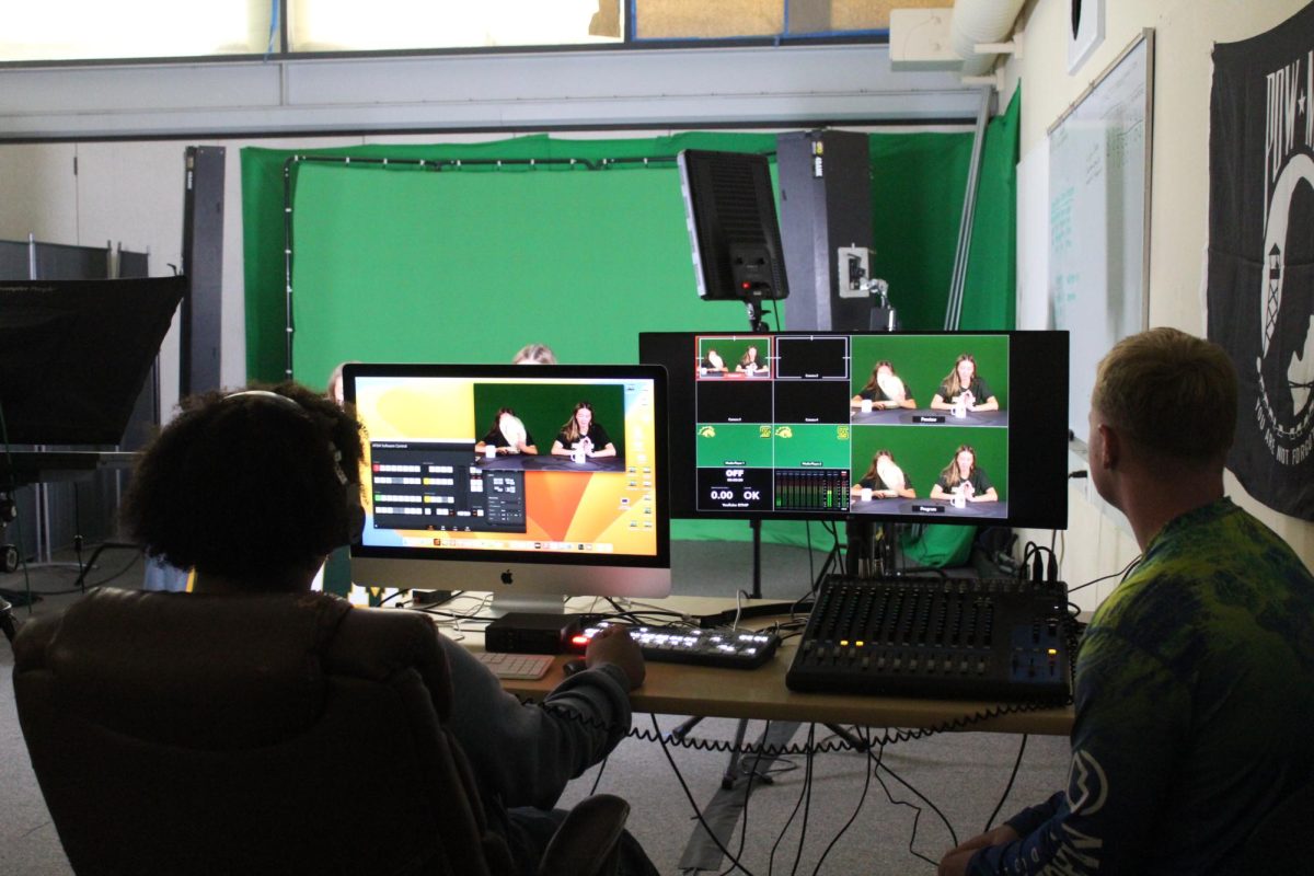 Seniors Malakhi Lindsay (left) and Brodie Crowther (right) prepare a teleprompter for a broadcasting
