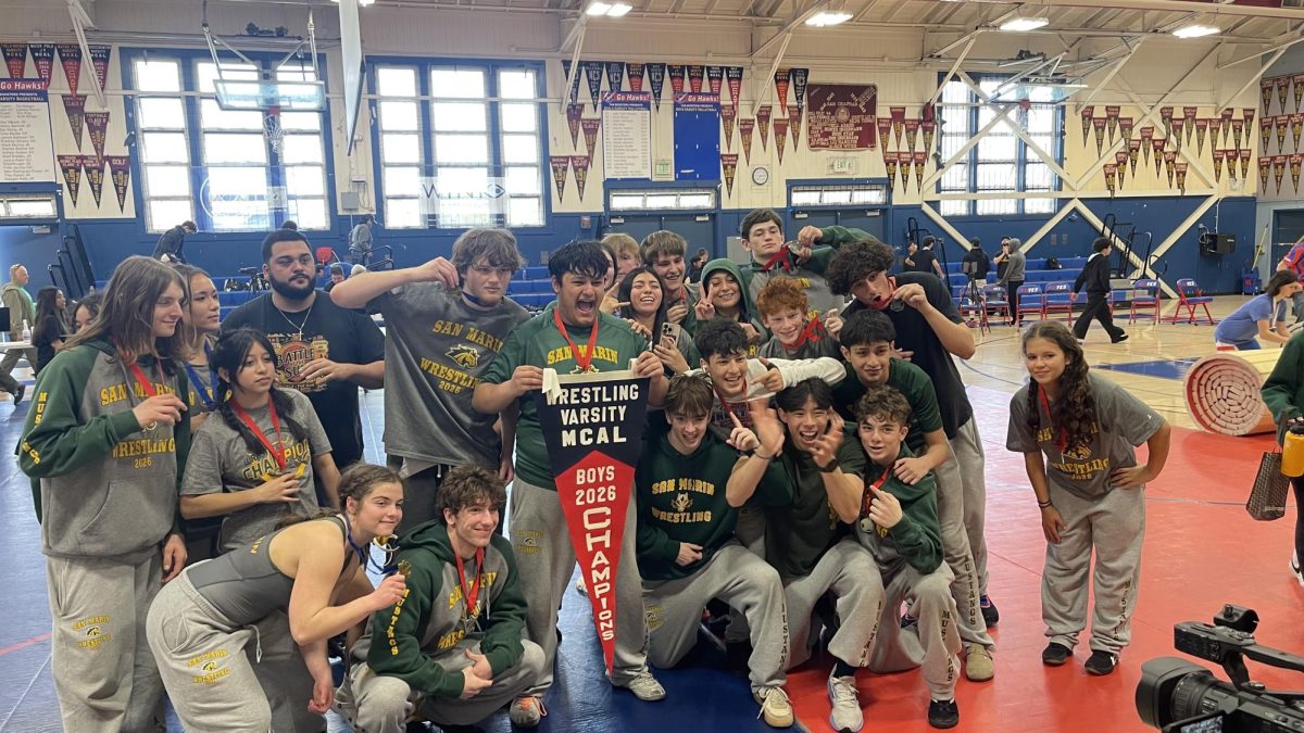 Members of the wrestling team pose with the boys' MCAL pennant. 