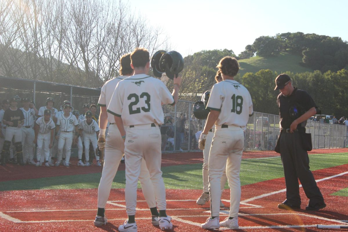The Mustangs celebrate at home plate after junior first baseman Dylan Procopio blasted a three-run shot to extend San Marin's lead over Novato.