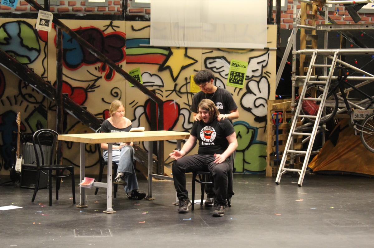 Drama students sophomore Stella Smith (left), senior Angel Yam (standing) and junior Flint Berberich (sitting), rehearse for their play, "How to make a Sandwich in 20 Easy Steps When All You Have is a Time Machine." 